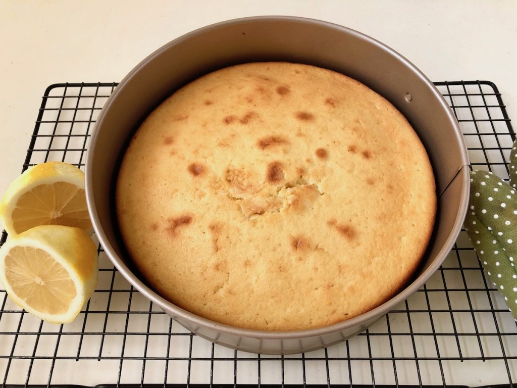 Freshly baked Lemon Ricotta Cake on a cooling tray.