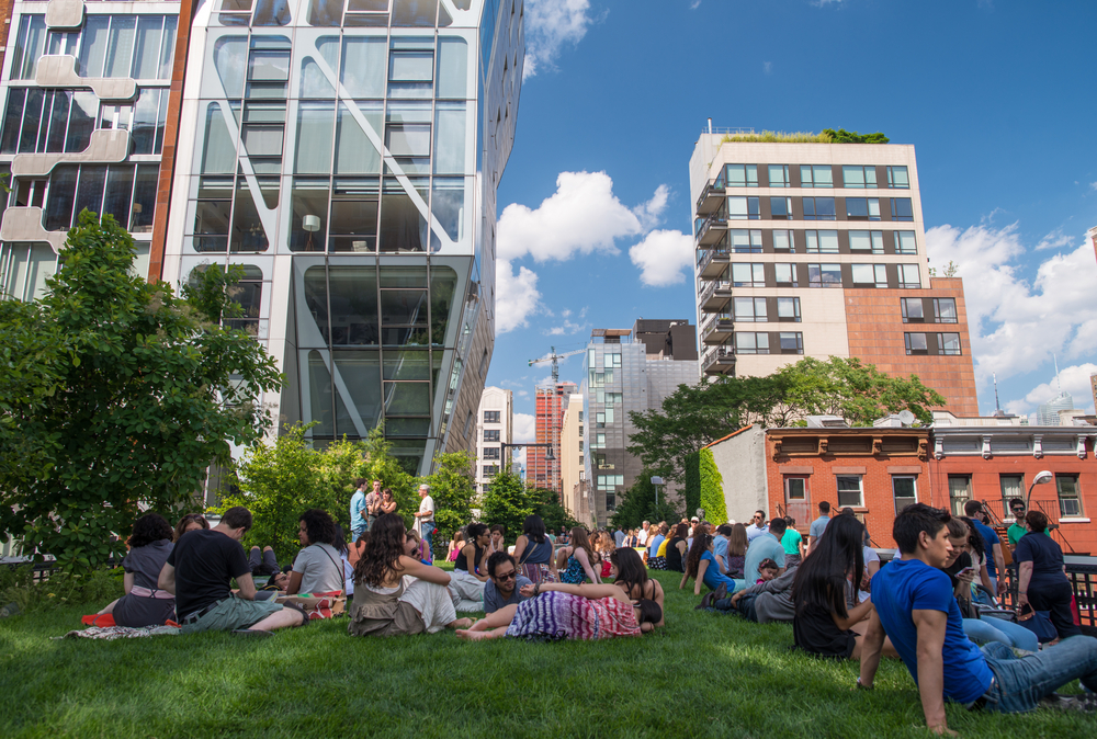 The High Line is a popular linear park built on the elevated train tracks above Tenth Ave in New York City.